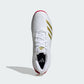 White athletic shoe with gold stripes on a white background