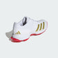White sports shoe with red sole and gold accents on a white background