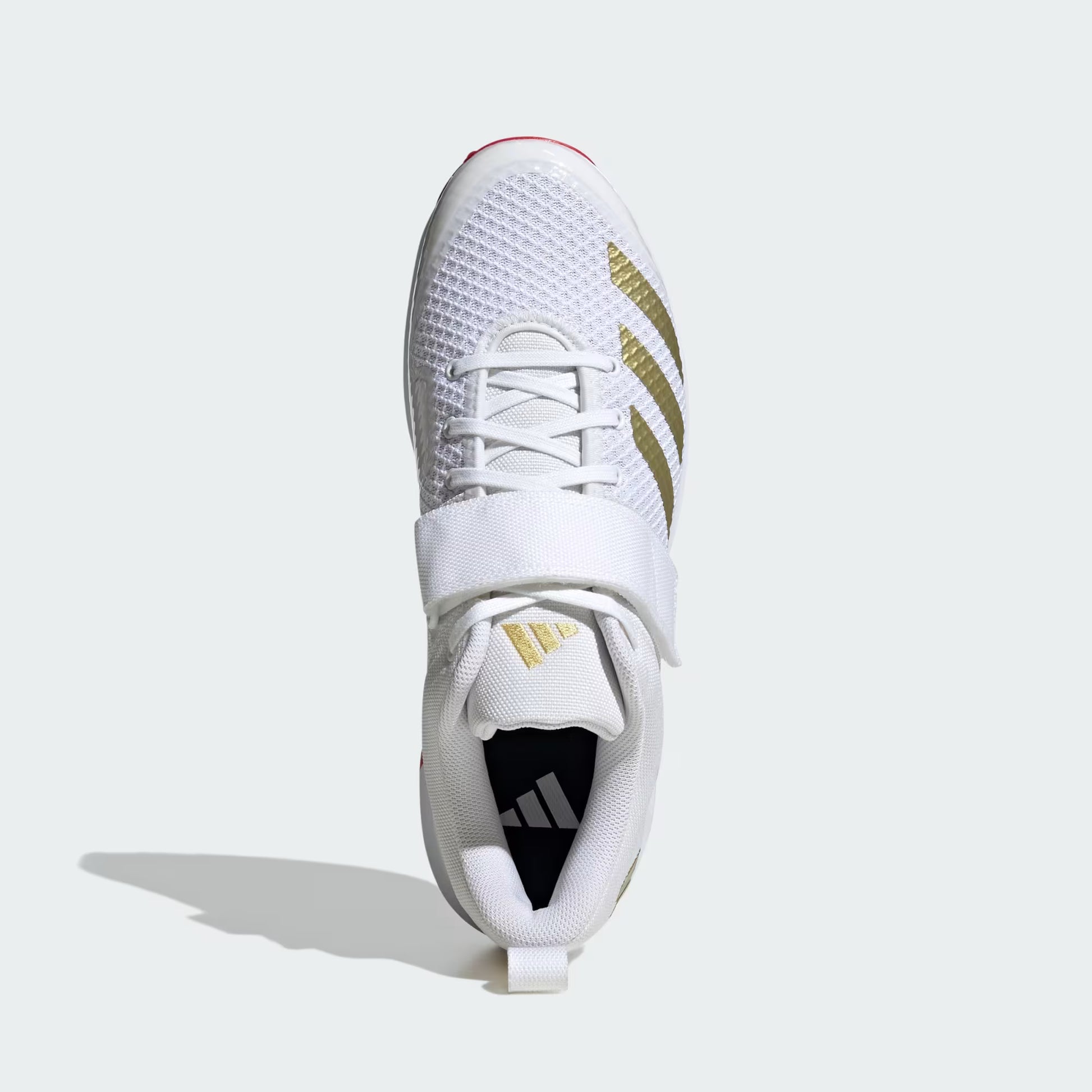 White athletic shoe with gold accents on a white background