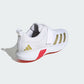 White athletic shoe with gold stripes and red sole on a white background