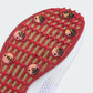 Close-up of a red insole with metallic buttons on a white background