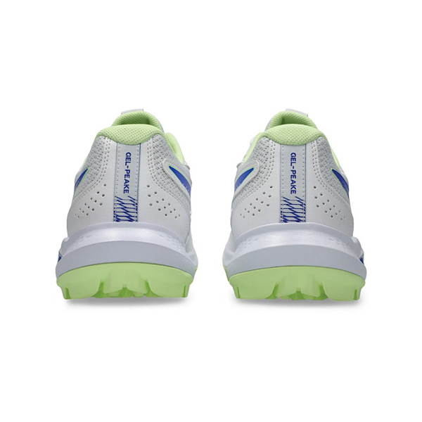 Side profile of white Asics cricket shoe with blue stripes, gel cushioning and light green studded sole