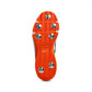 Close-up of orange cleat sole with metal studs on a white background